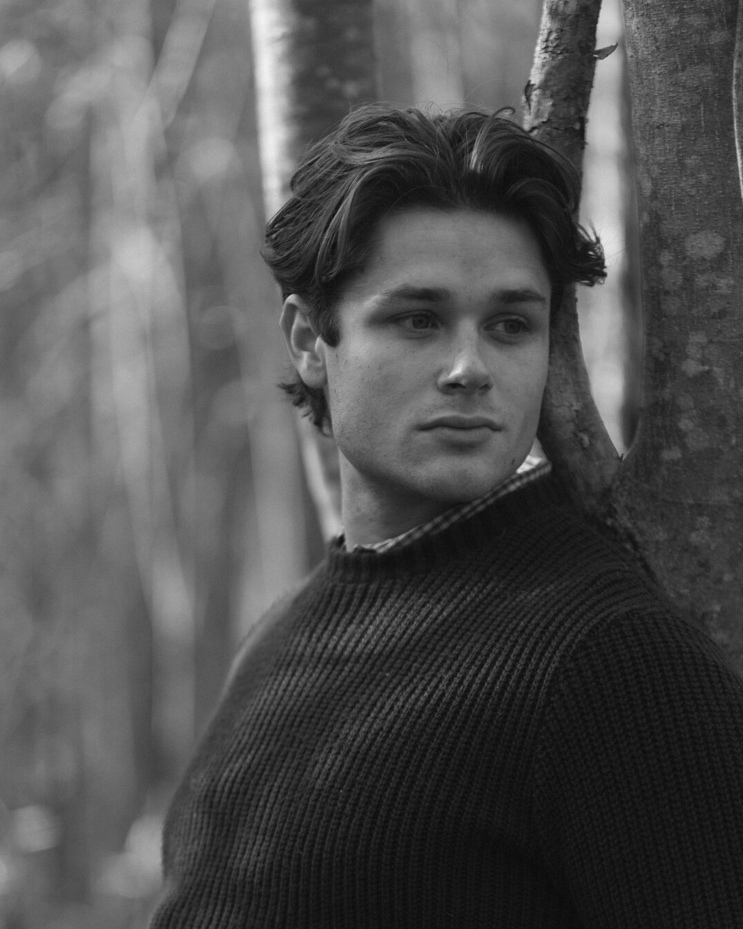 Portrait of a man with light stubble in a dark sweater