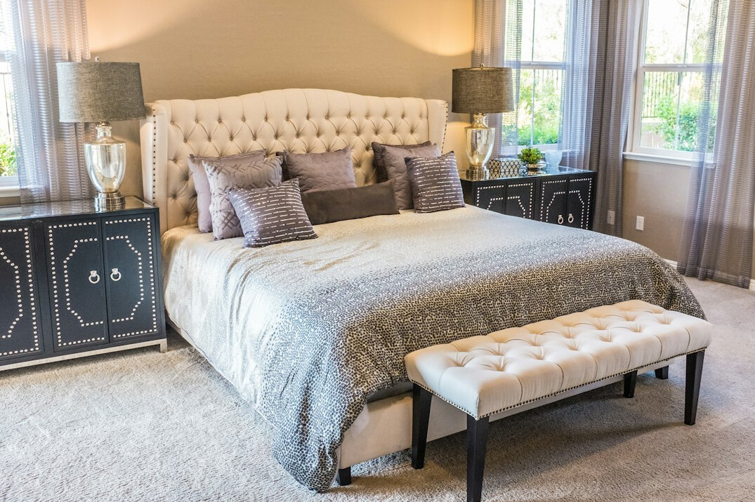 Bedroom with an upholstered headboard and soft linen